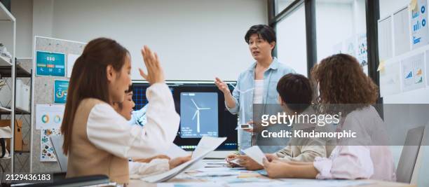 asian business people team brainstorm meeting in sustainable corporate office. presentation esg project planning, solar panel, wind turbine power energy generation. environmental conservation concept - group video conference stock pictures, royalty-free photos & images