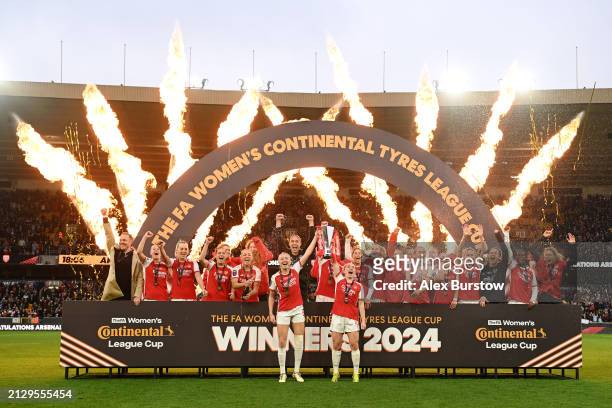 Leah Williamson and Kim Little of Arsenal lift the Continental Tyres League Cup Trophy after their team's victory in the FA Women's Continental Tyres...