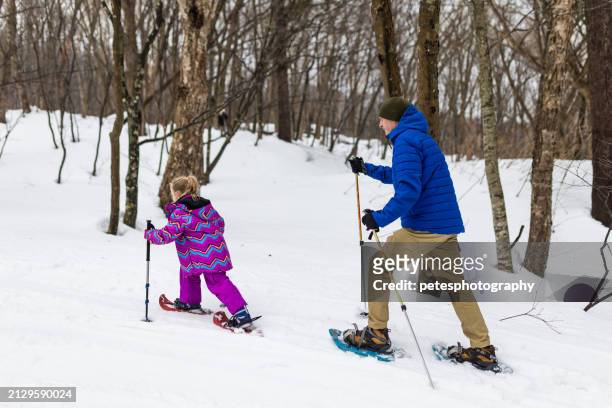 father and daughter snowshoeing together - iwate prefecture stock pictures, royalty-free photos & images