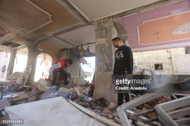 Palestinians are seen at the area amid rubble after an Israeli attack on Jenin neighborhood in Rafah, Gaza on April 04, 2024. Some houses were...