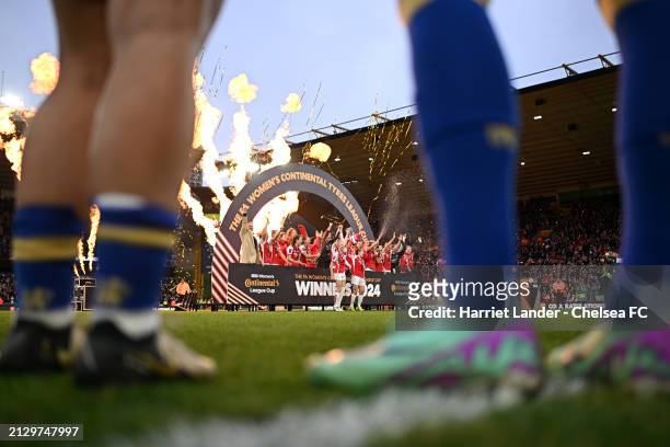 Arsenal women celebrate with the FA Women's Continental Tyres League Cup trophy as Chelsea look on following the FA Women's Continental Tyres League...
