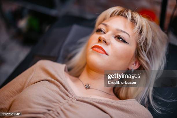 young woman getting her lips tattooed at a beauty salon - lip tattooing stock pictures, royalty-free photos & images