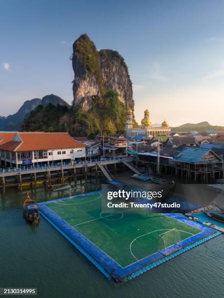 aerial view of floating football field on panyee island in phang nga bay in thailand - floating island stock pictures, royalty-free photos & images