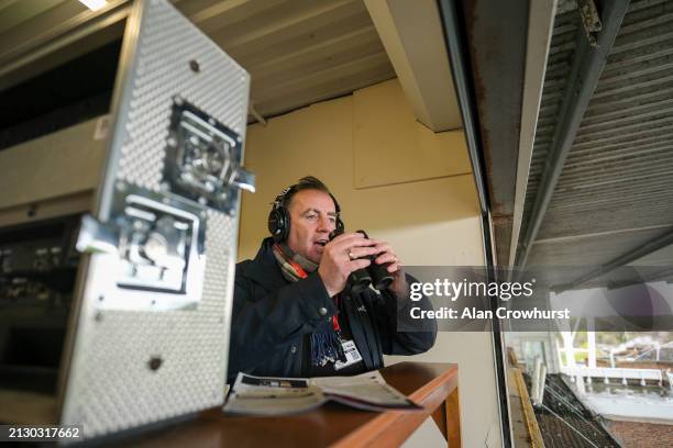 Commentator John Hunt in the commentary box at Kempton Park Racecourse on April 01, 2024 in Sunbury, England.