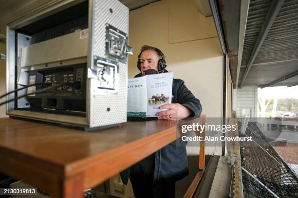 Commentator John Hunt in the commentary box at Kempton Park Racecourse on April 01, 2024 in Sunbury, England.