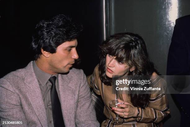 American baseball player Lee Mazzilli, wearing a grey suit over a grey shirt and a black tie, with American actress Kim Delaney, who wears a...