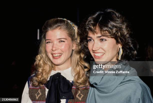 American actress Taylor Miller, wearing a knitted vest over a white blouse with a black bow, and her 'All My Children' co-star, American actress Kim...