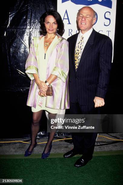 Belgian fashion designer Diane von Furstenberg, wearing a pink-and-yellow jacket, and American businessman Barry Diller, who wears a pinstripe suit,...