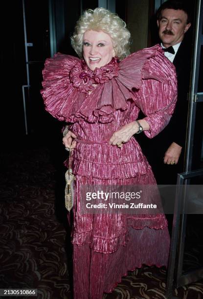 American comedian and actress Phyllis Diller, wearing a ruffled maroon evening gown with high shoulders, attends the 32nd Annual Thalians Ball, at...