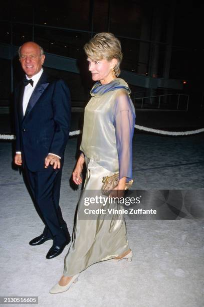 American businessman Barry Diller, wearing a tuxedo and bow tie, and American actress Candice Bergen, who wears a pale green evening gown with blue...