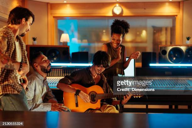 friends playing instruments and having fun in the music studio - muse band stock pictures, royalty-free photos & images