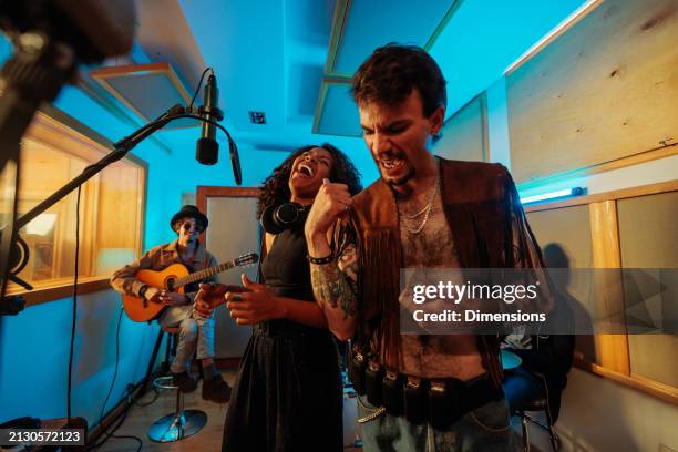 artists recording a song in the studio - liedjesschrijver stockfoto's en -beelden