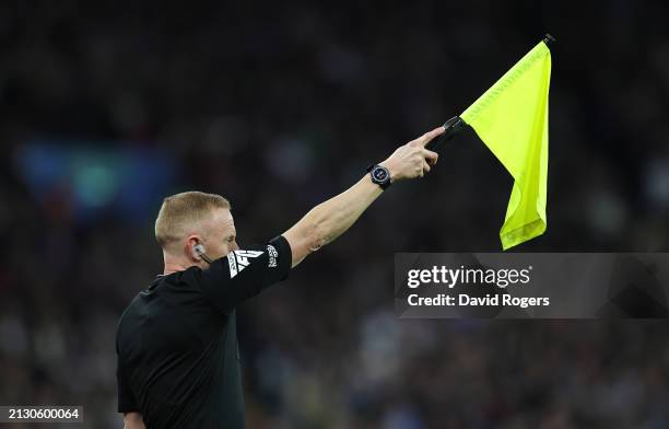 An assistant referee, uses his flag to signal offside during the Premier League match between Aston Villa and Wolverhampton Wanderers at Villa Park...