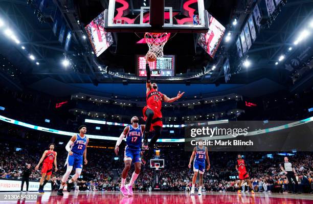 Garrett Temple of the Toronto Raptors and Buddy Hield of the Philadelphia 76ers goes to the basket against Buddy Hield of the Philadelphia 76ers...