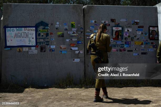 Female combat soldiers from the "Ariyot Hayarden" unit stands outside a makeshift bomb shelter where the words "we will dance again" are seen on a...