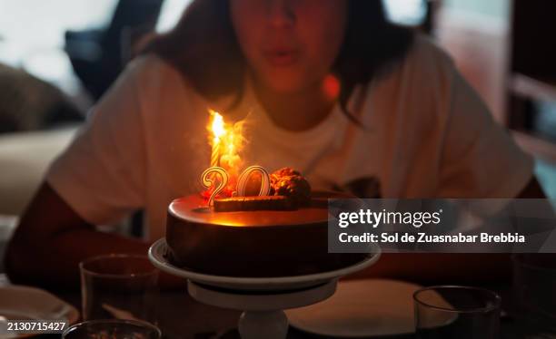 birthday girl blows on the birthday cake - birthday candle number stock pictures, royalty-free photos & images
