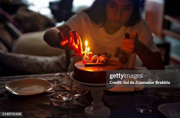 birthday girl lighting the candles on the birthday cake - birthday candle number stock pictures, royalty-free photos & images