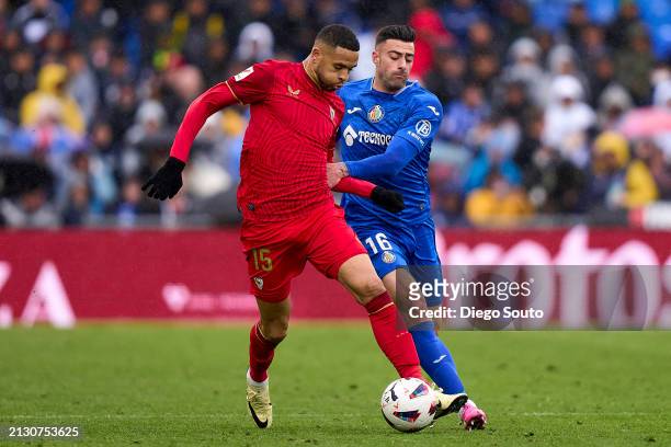 Diego Rico of Getafe CF battle for the ball with Youssef En Nesyri of Sevilla FC during the LaLiga EA Sports match between Getafe CF and Sevilla FC...
