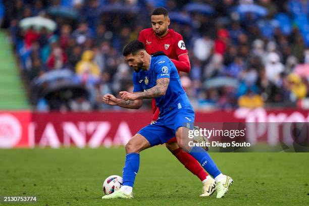 Omar Alderete of Getafe CF battle for the ball with Youssef En Nesyri of Sevilla FC during the LaLiga EA Sports match between Getafe CF and Sevilla...