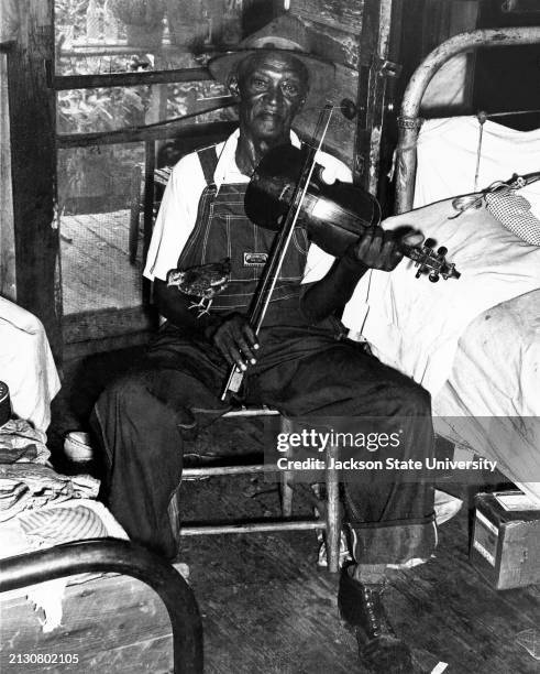 Tom Dumas is in his nineties and still plays traditional country music on both the fiddle and banjo.