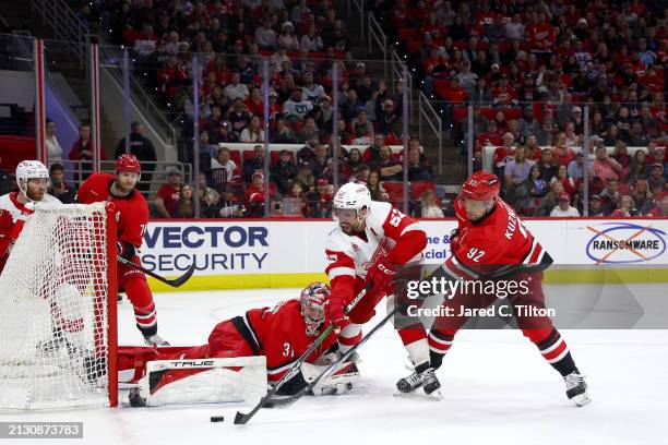 Frederik Andersen of the Carolina Hurricanes makes a save against David Perron of the Detroit Red Wings during the first period of the game at PNC...