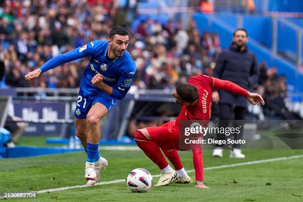 Juan Iglesias of Getafe CF battle for the ball with Nemanja Gudelj of Sevilla FC during the LaLiga EA Sports match between Getafe CF and Sevilla FC...