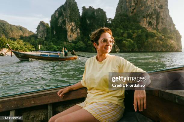 a mature woman sitting on the boat - white asian female stock pictures, royalty-free photos & images
