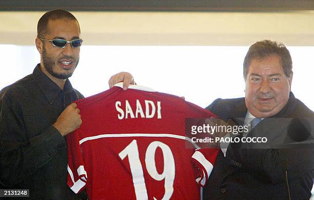 Saadi Kadhafi , son of Libyan leader Moamar Kadhafi, holds up his new Perugia soccer team jersey with the Italian team's president Luciano Gaucci,...