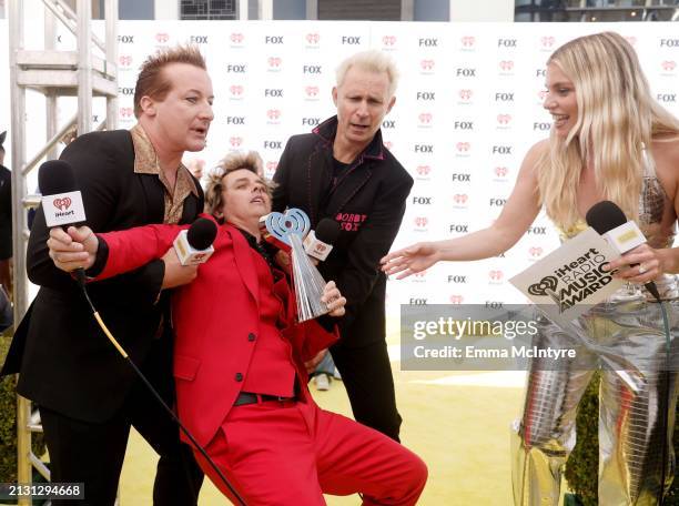 Tré Cool, Billie Joe Armstrong, and Mike Dirnt of Green Day and Tanya Rad attend the 2024 iHeartRadio Music Awards at Dolby Theatre in Los Angeles,...