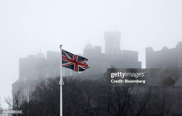 British Union flag against a backdrop of Edinburgh Castle in Edinburgh, UK, on Tuesday, April 2, 2024. UK companies expect to raise their own prices...