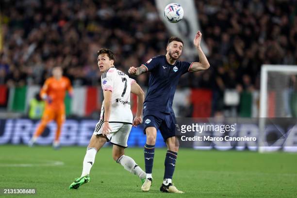 Mario Gila of Ss Lazio and Federico Chiesa of Juventus Fc battle for the ball during the Coppa Italia semi-final first leg match between Juventus Fc...