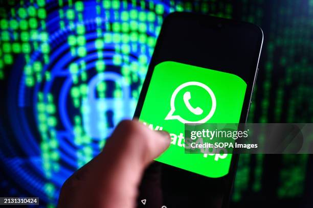 In this photo illustration a WhatsApp logo is displayed on a smartphone with cyber security symbol on the background.