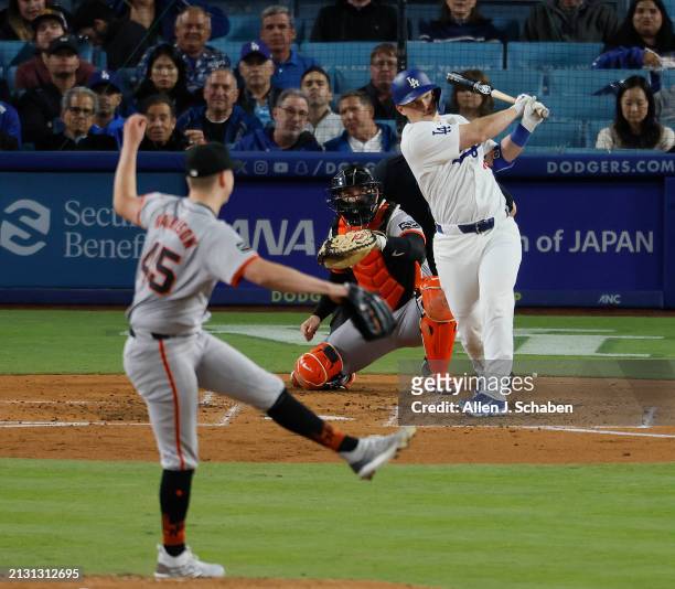 Los Angeles, CA Giants starting pitcher Kyle Harrison delivers as Dodgers' Will Smith hits an RBI double, scoring designated hitter Shohei Ohtani in...