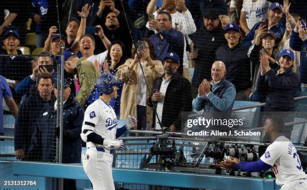 Los Angeles, CA Dodgers right fielder Teoscar Hernández, right, showers Dodgers designated hitter Shohei Ohtani, #17, with sunflower seeds after he...