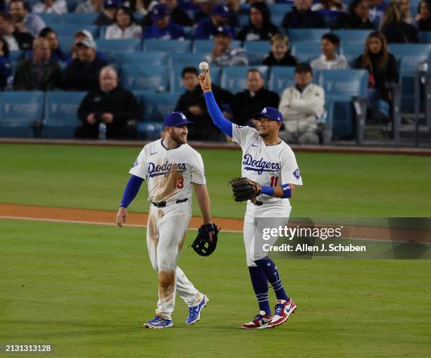 Los Angeles, CA Dodgers third baseman Max Muncy, left, watches Miguel Rojas, throw against the Giants at Dodger Stadium in Los Angeles Tuesday, April...