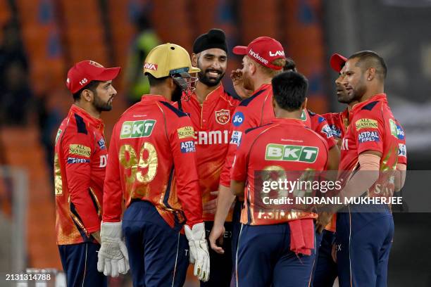 Punjab Kings' Harpreet Brar celebrates with teammates after taking the wicket of Gujarat Titans' Kane Williamson during the Indian Premier League...