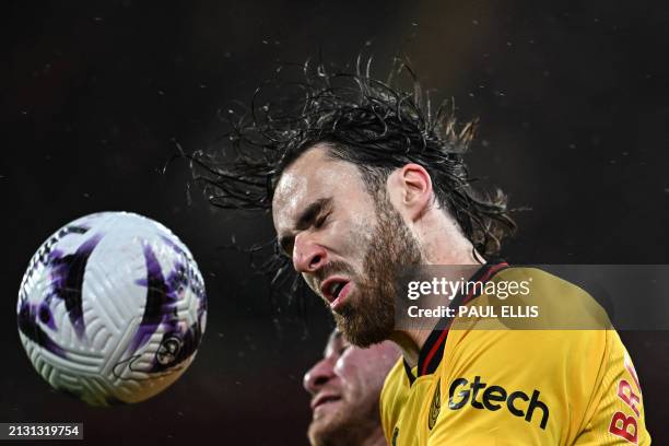 Sheffield United's Chilean striker Ben Brereton Diaz heads the ball during the English Premier League football match between Liverpool and Sheffield...