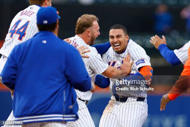 Tyrone Taylor of the New York Mets is jumped by Pete Alonso and other teammates after hitting an RBI single in the ninth inning to defeat the Detroit...