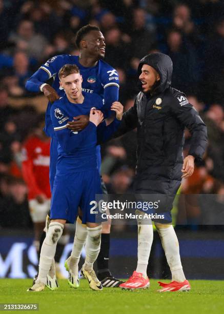 Cole Palmer of Chelsea celebrates scoring the winning goal with Benoit Badiashile and Malo Gusto during the Premier League match between Chelsea FC...