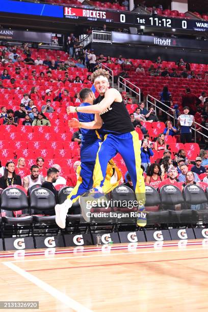 Brandin Podziemski and Stephen Curry of the Golden State Warriors warm up before the game against the Houston Rockets on April 4, 2024 at the Toyota...