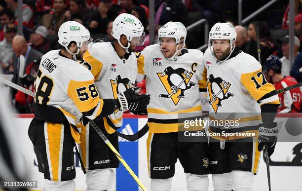 Penguins defenseman Kris Letang , defenseman Pierre-Olivier Joseph , center Sidney Crosby , and right wing Bryan Rust celebrate after Joseph's first...