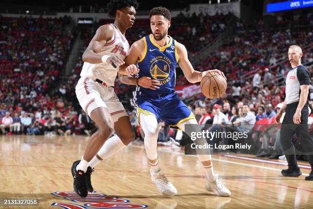 Klay Thompson of the Golden State Warriors drives to the basket against Amen Thompson of the Houston Rockets during the game on April 4, 2024 at the...