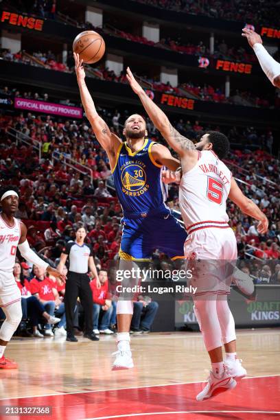 Stephen Curry of the Golden State Warriors shoots the ball over Fred VanVleet of the Houston Rockets during the game on April 4, 2024 at the Toyota...