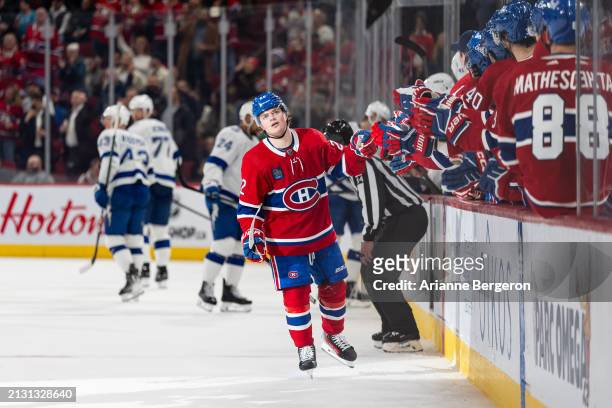 Cole Caufield of the Montreal Canadiens celebrates a goal with the bench during the third period of the NHL regular season game between the Montreal...