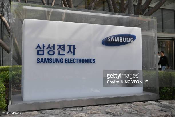 Man walks past a signboard of Samsung Electronics displayed outside the company's Seocho building in Seoul on April 5, 2024. Samsung Electronics said...