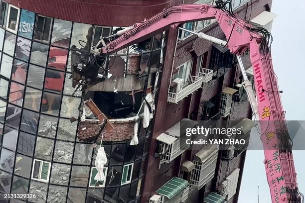 This screengrab taken from AFPTV video footage on April 5, 2024 shows heavy equipment being used to demolish the Uranus building, which was damaged...