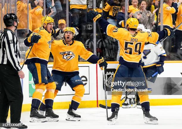 Michael McCarron celebrates his goal with Kiefer Sherwood and Roman Josi of the Nashville Predators against the St. Louis Blues during an NHL game at...