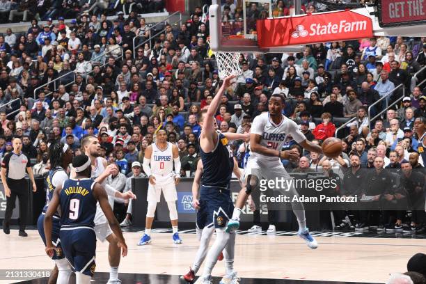Norman Powell of the LA Clippers drives to the basket during the game against the Denver Nuggets on April 4, 2024 at Crypto.Com Arena in Los Angeles,...