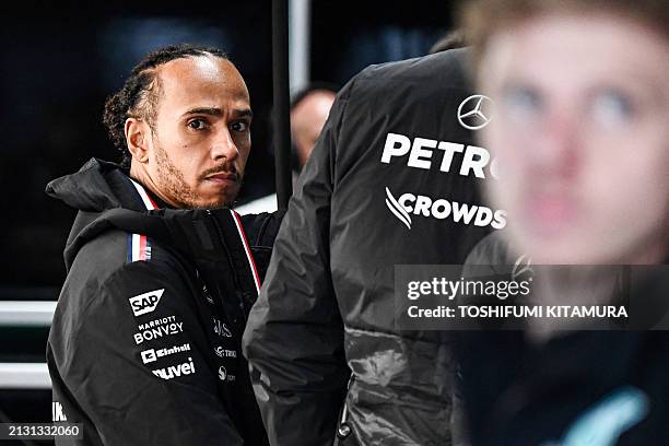 Mercedes' British driver Lewis Hamilton looks on during the second practice session ahead of the Formula One Japanese Grand Prix race at the Suzuka...