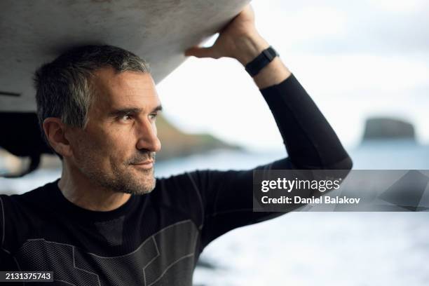 surfing at sunrise. heading for the top. - wetsuit stock pictures, royalty-free photos & images